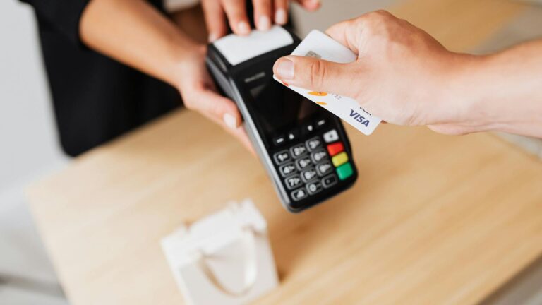 A Person Paying Cashless Using Credit Card